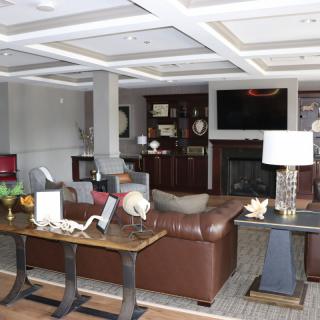 A stylish living room featuring a leather sofa, fireplace, and modern dcor.