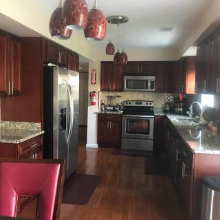 A modern kitchen with stainless steel appliances and wood cabinets.