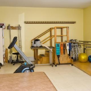 A well-equipped rehabilitation and exercise space featuring various fitness tools.