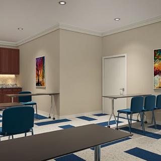 A modern classroom interior with tables, chairs, and colorful artwork on the walls.