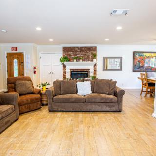 A cozy living room with comfortable seating and a fireplace.