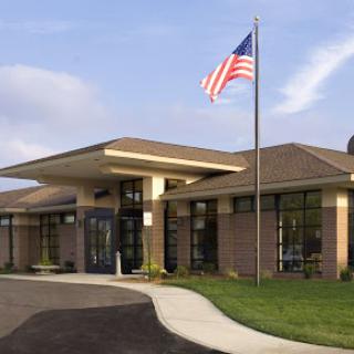 A modern building with an American flag flying at the entrance.
