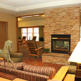 A cozy living room with a brick fireplace and comfortable seating.