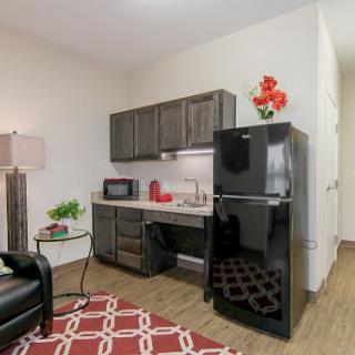 A cozy kitchen area featuring modern appliances and stylish decor.