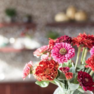 A vibrant bouquet of zinnias adds a splash of color to the room.
