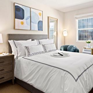 A modern bedroom with stylish decor and comfortable bedding.