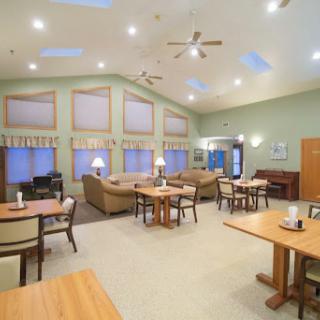 A cozy lounge and dining area featuring comfortable seating and ample natural light.
