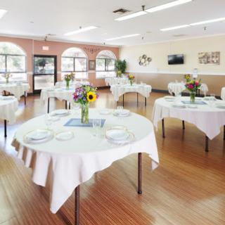 A beautifully arranged dining area with elegant tables set for a gathering.