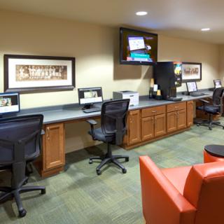 A modern office workspace featuring multiple computer stations and comfortable seating.