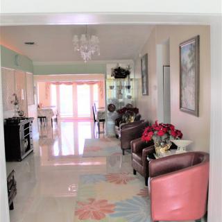 A cozy living space with modern decor and an open kitchen.