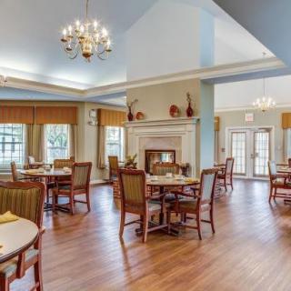 A cozy dining area with elegant lighting and classic wooden furniture.