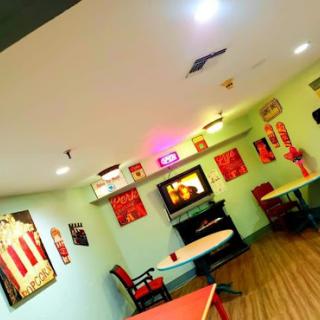 A cozy and vibrant caf interior featuring artistic decorations and comfortable seating.