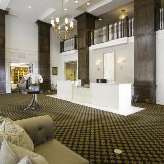 Elegant hotel lobby with a modern reception desk and stylish decor.