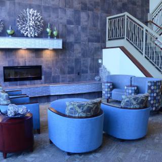 A stylish and modern living room featuring a cozy seating arrangement, a fireplace, and elegant decor.