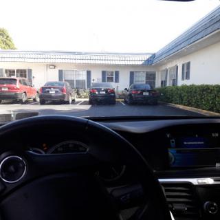 View from inside the car parked in a motel's parking lot.