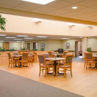 A spacious dining area with wooden tables and chairs, creating a warm and inviting atmosphere.