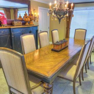 Elegant dining room with a wooden table and chandelier.