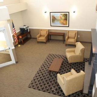 A spacious lobby area with comfortable seating and a decorative rug.