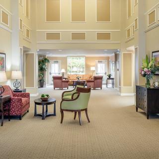 A spacious and elegantly decorated living room with comfortable seating and tasteful decor.