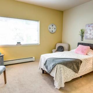 A cozy and well-decorated bedroom with a comfortable bed and neutral color palette.