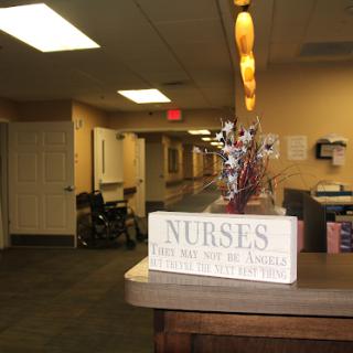 A welcoming view of a healthcare facility featuring a decorative sign for nurses.