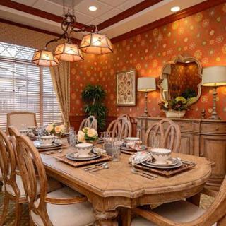 A beautifully designed dining room featuring elegant wooden furniture and a warm, inviting atmosphere.