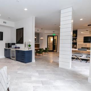 A modern, open-concept living area featuring a kitchenette and comfortable seating.