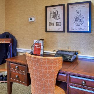 A retro-themed office space featuring a wooden desk and a vintage typewriter.