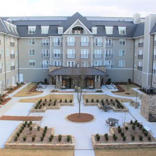 A symmetrical building with a landscaped courtyard and modern architecture.