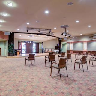An empty conference room arranged with chairs, ready for a meeting or event.