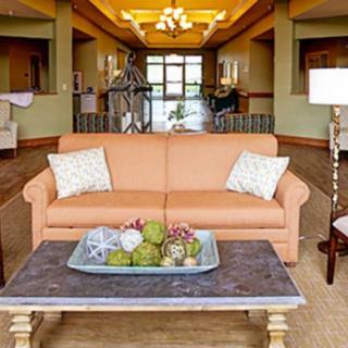 A well-decorated living area with a sofa, coffee table, and decorative elements.