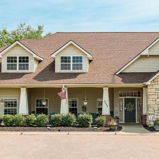 A suburban house with a gabled roof and front porch.