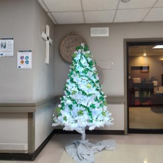 A beautifully decorated Christmas tree with green and white lights, bringing holiday cheer to the indoor space.