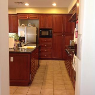 A modern kitchen with wooden cabinets and stainless steel appliances.