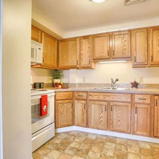 A cozy kitchen featuring wooden cabinets and standard appliances.