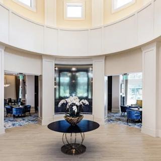 Luxurious hotel lobby with elegant design and central display table.