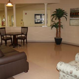 A cozy lobby area with seating and a potted plant.