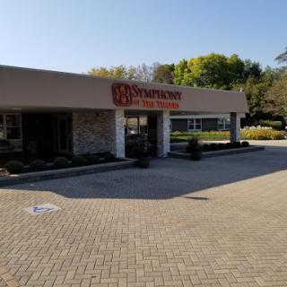 A view of a commercial building with signage under a clear blue sky.