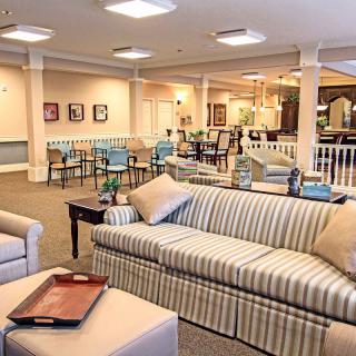 A cozy living room with striped sofas and elegant interior design.