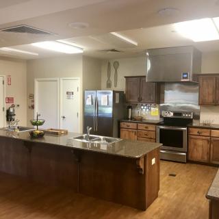 A modern kitchen with stainless steel appliances and wooden cabinets.