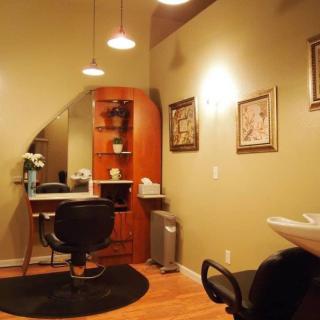 A cozy hair salon interior with a styling station and comfortable lighting.