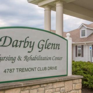 Sign for Darby Glenn Nursing & Rehabilitation Center with building in the background.