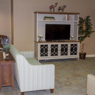 A cozy living room setup with a television and modern furniture.