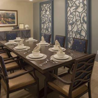 An elegantly set dining table with decorative panels in a stylish dining room.