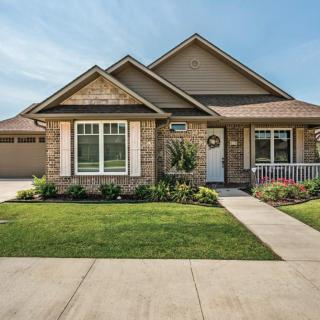 A charming suburban home with a well-maintained lawn and a welcoming front porch.