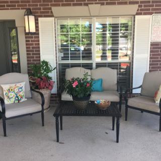 A cozy outdoor seating area with comfortable chairs and decorative touches.