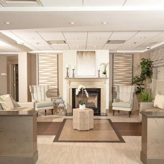 A modern and elegant lobby with comfortable seating and a fireplace.