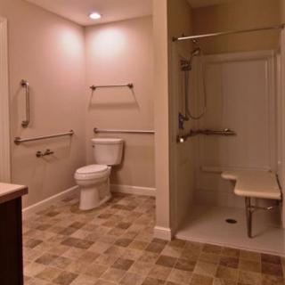 Accessible bathroom with grab bars and a walk-in shower.