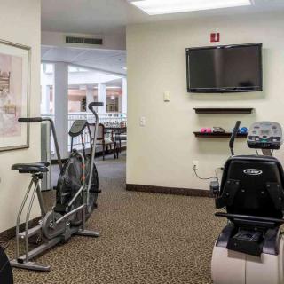 A small indoor gym with exercise equipment and a television.