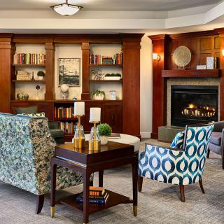 A cozy living room with stylish furniture and a warm fireplace.